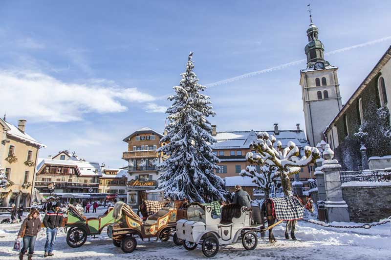 Traditional horse & cart in the snowy centre of Megève in the French Alps