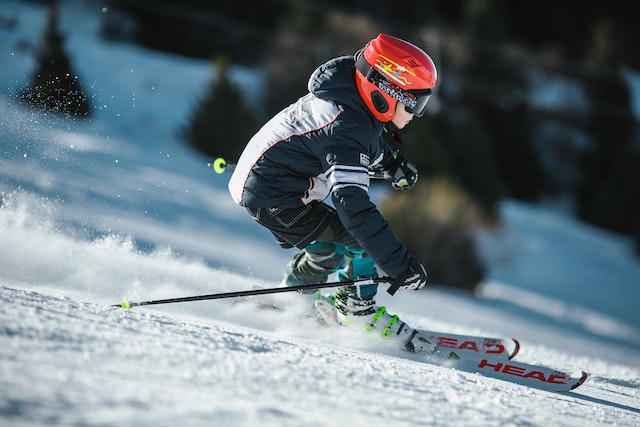 Close up of a boy skiing parallel down an alpine slopes
