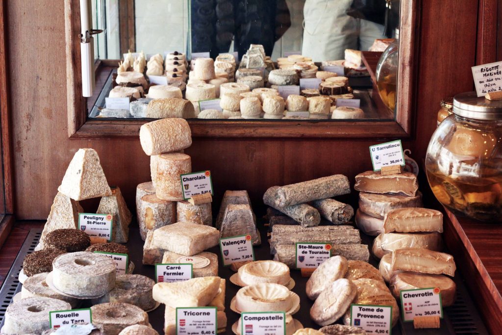 The Savoie Cheese Route - cheeses laid out in a Savoie cheesemongers