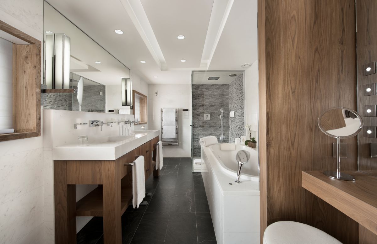 Hotel Fouquet's Courchevel - large bright bathroom with bath walk in shower his and hers sinks heated towel rail and separate vanity area
