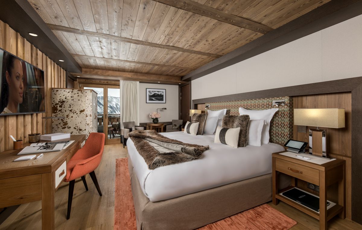 Hotel Fouquet's Courchevel - Spacious double bedroom with seating area large tv wardrobe desk and private balcony
