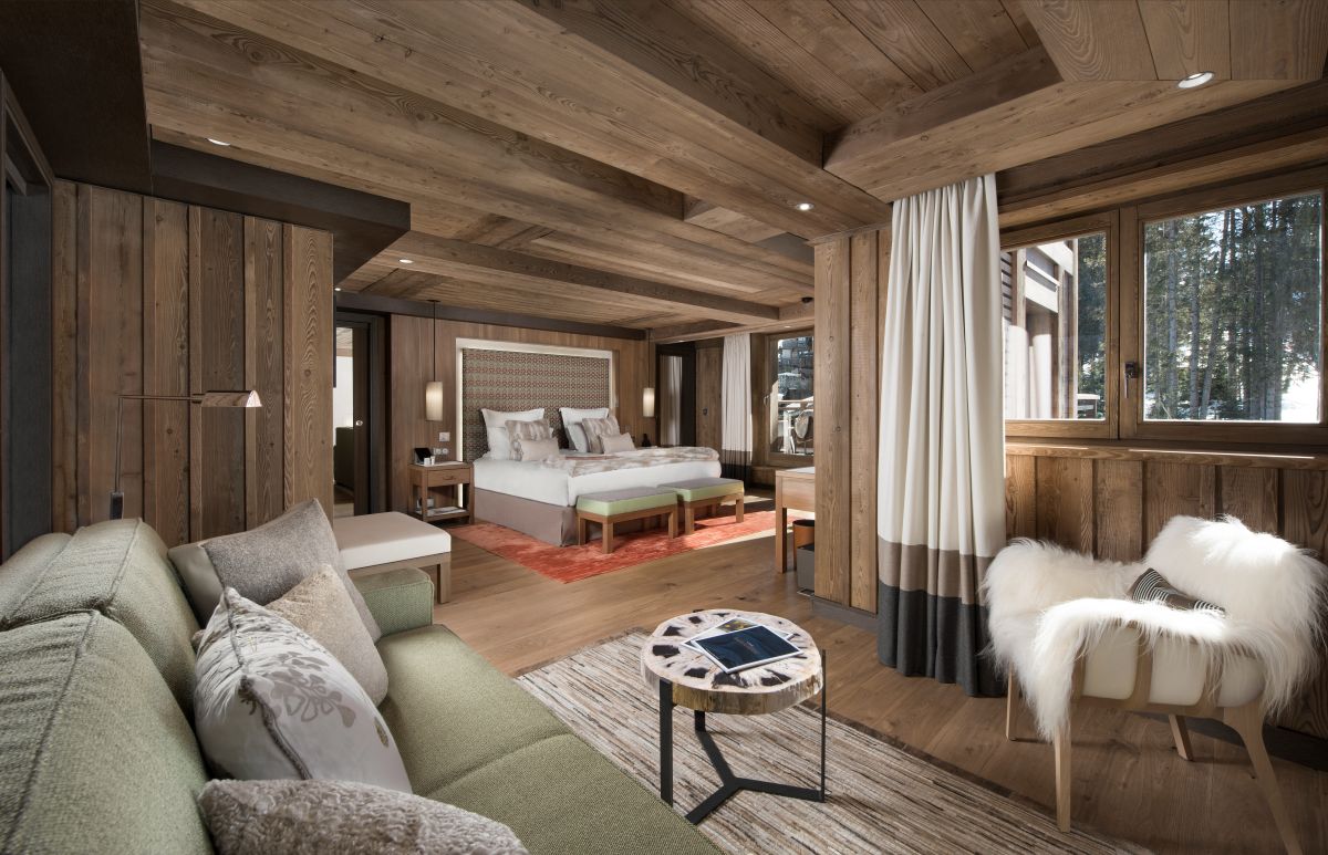 Hotel Fouquet's Courchevel - Spacious bedroom with semi private living room sofa chair table and balcony