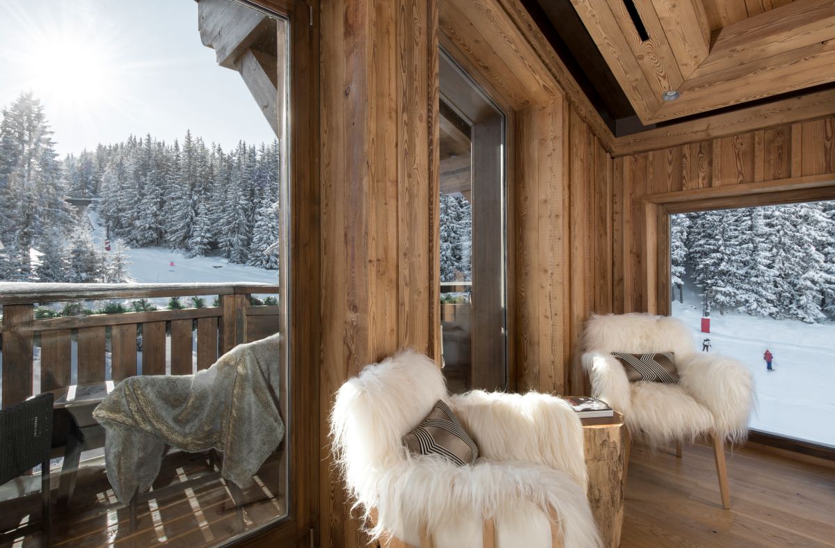 Hotel Fouquet's Courchevel - door leading out to private baclony with cosy seats and views of the slopes and forest