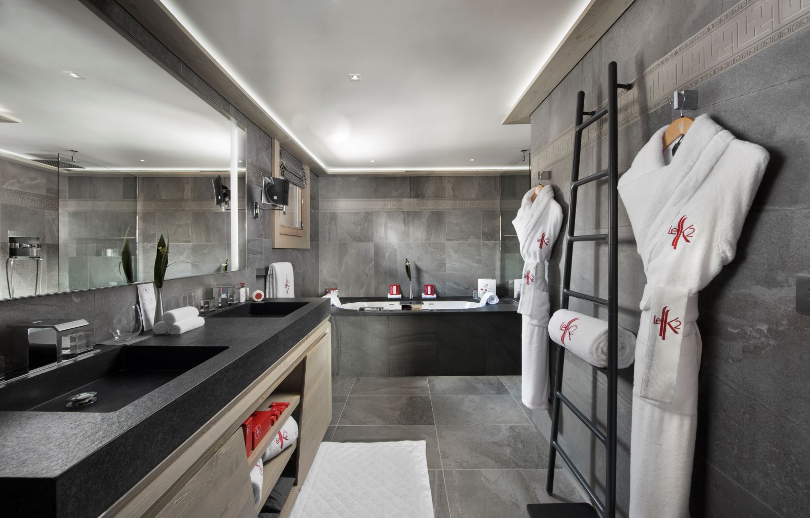 Hotel Le K2 Altitude Courchevel - large contemporary bathroom with bath two sinks large mirror and heated towel rail