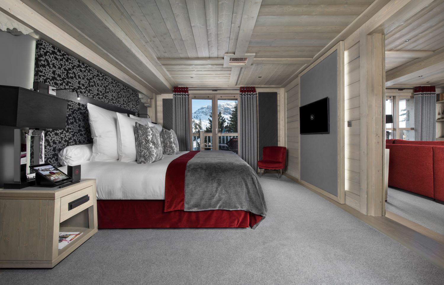 Hotel Le K2 Altitude Courchevel - expansive king size bedroom off a living room with tv seats and private balcony access