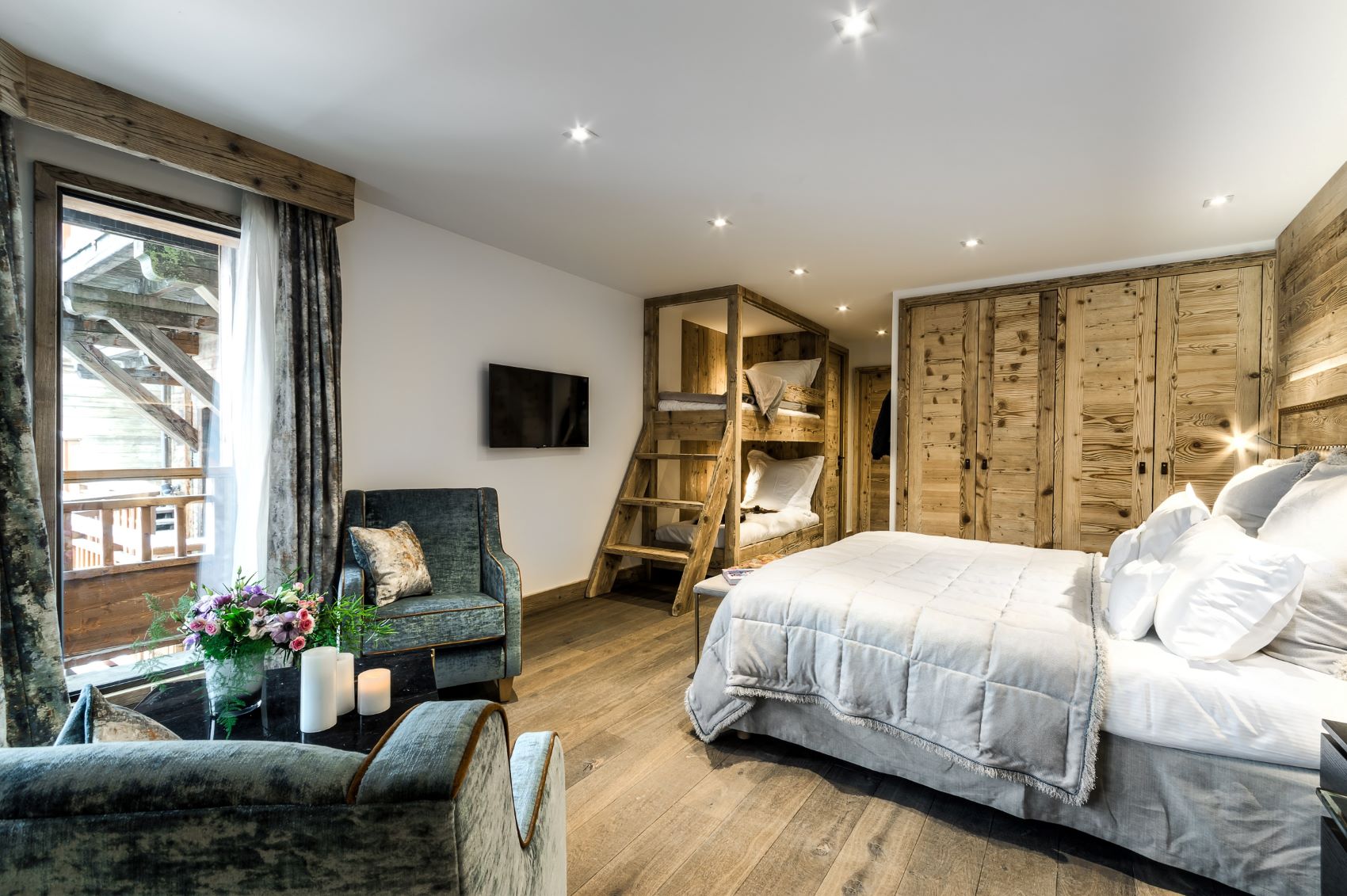 Hotel La Sivolière Courchevel - Bright family room with double bed bunk bes comfy seating area wardrobes tv and large window
