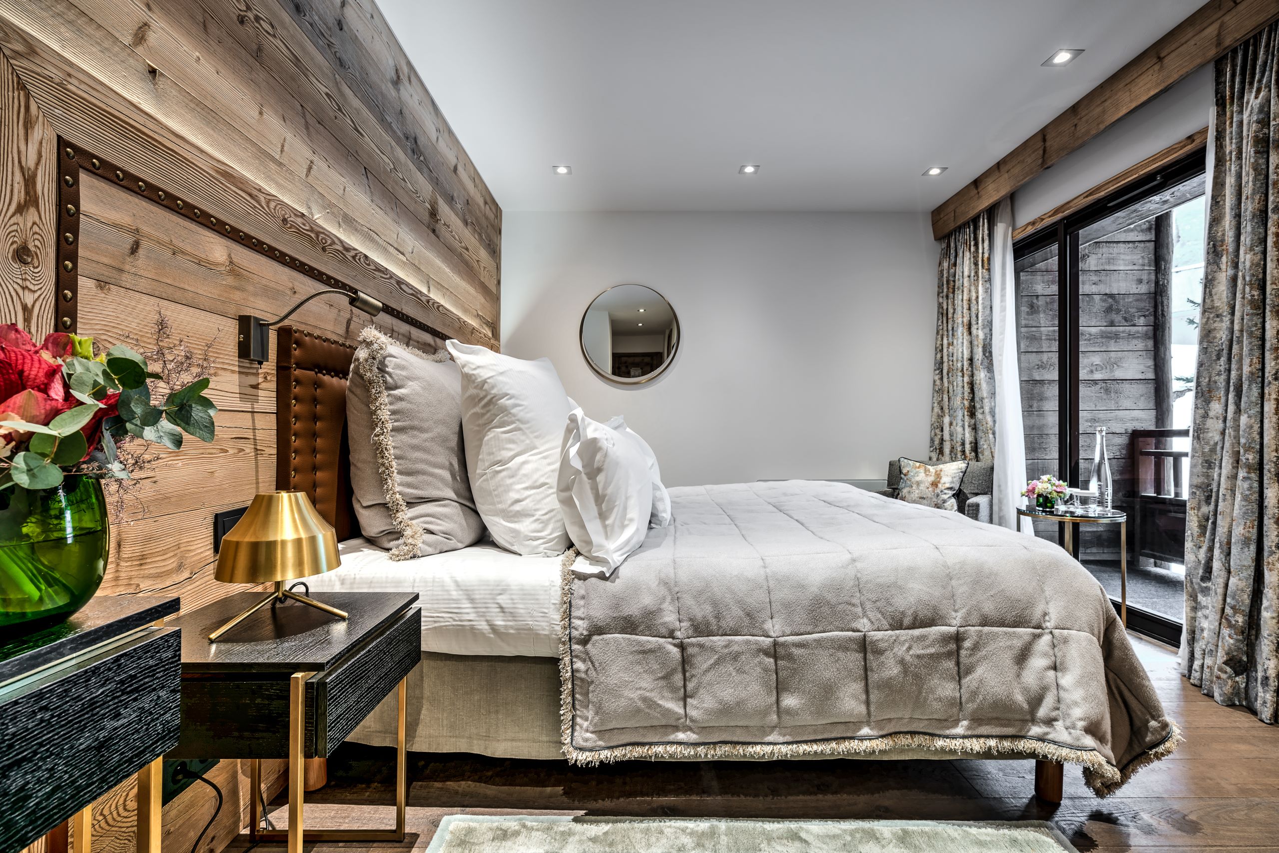 Hotel La Sivolière Courchevel - Well lit bedroom with seating are mirror and access to private balcony