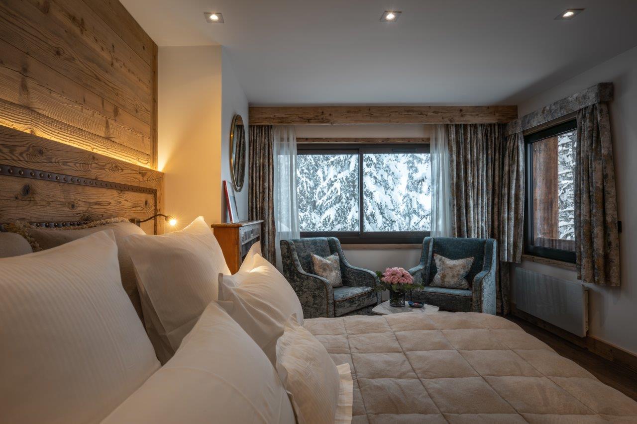 Hotel La Sivolière Courchevel - warm comfortable double beroom with seating and duel aspect windows