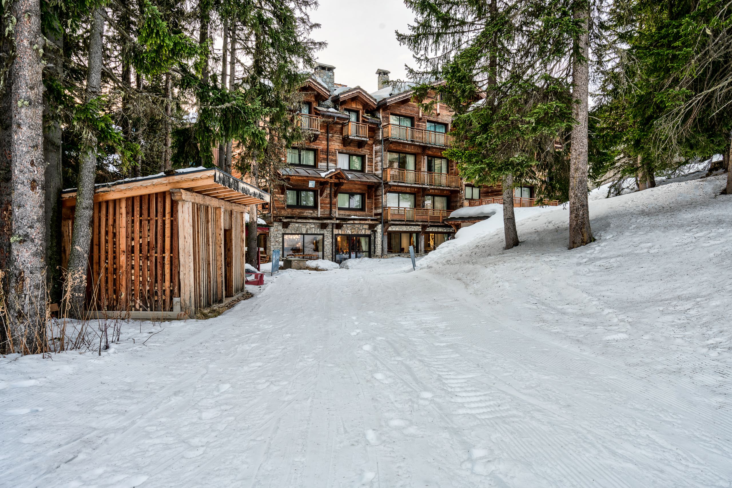 Hotel La Sivolière Courchevel - Exterior during the day with snow and trees