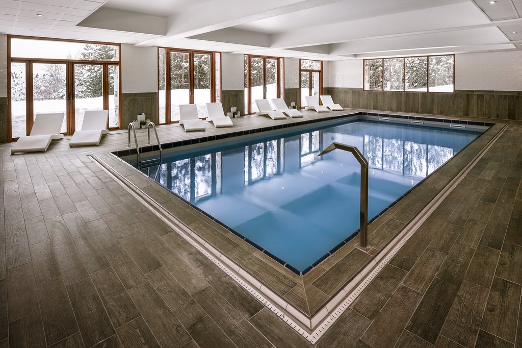 Hotel Le Pic Blanc Alpe d'Huez - Hotel indoor pool with loungers and a forest view